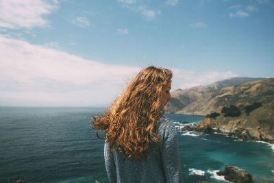 woman on beachside cliff