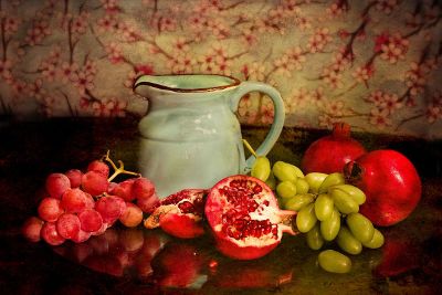 pitcher with fruit around it