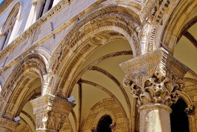 pigeons sitting on old stone arches