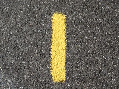 yellow line of paint on road