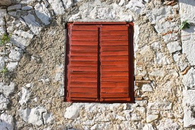 shuttered window infused in rock