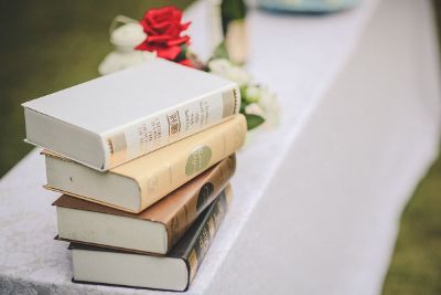 a lovely white table with a stack of books