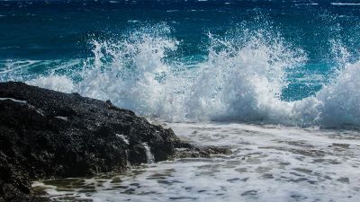 beautiful wave splashing against a rock