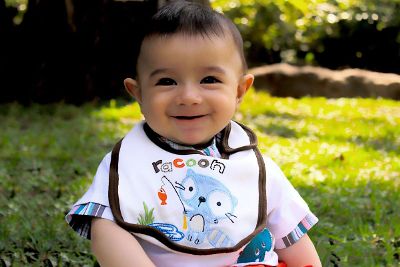 smiling baby with bib