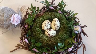 three eggs in a decorative nest