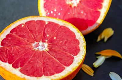 two grapefruit halves on a blue cloth