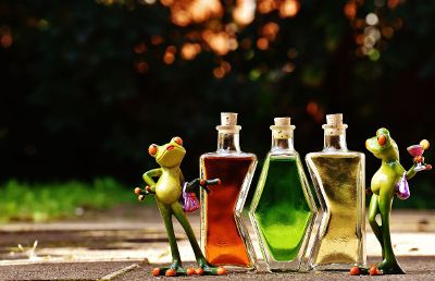 frog figures next to vials