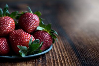 ripe strawberries on wood surface