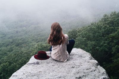 women sit on the rock