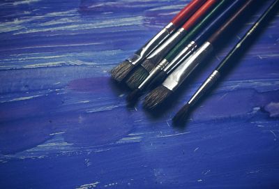 paint brushes on blue table