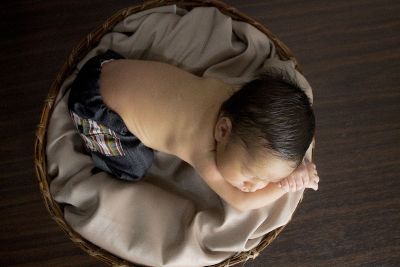 sleeping baby boy in a basket