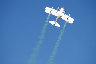 flying airplane with yellow smoke