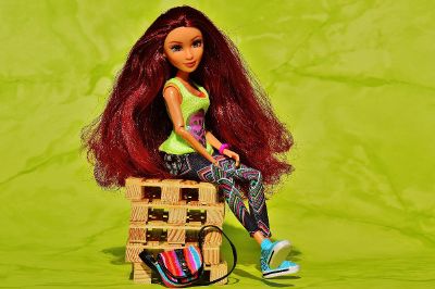 red haired doll sitting on toys