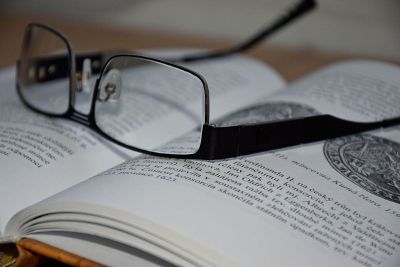 glasses laying on an open book