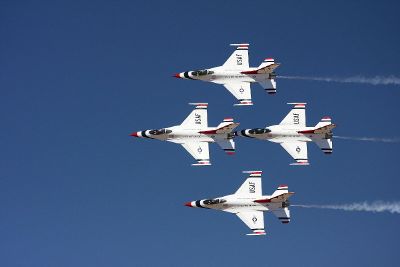 four fighter jets flying in formation