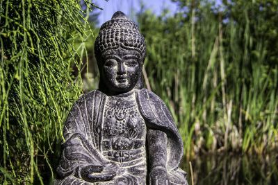 large black buddha statue sitting outside