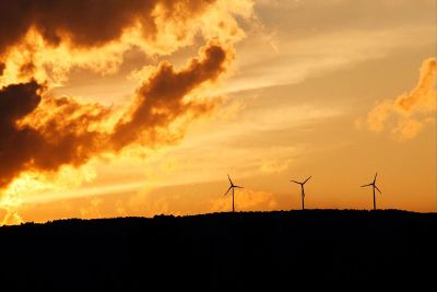 windmills against orange sky