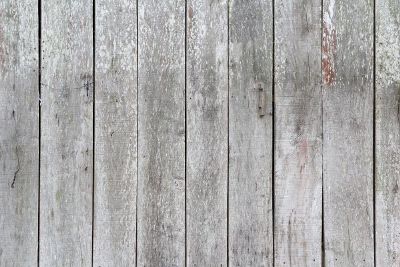 a weathered grayed wooden fence