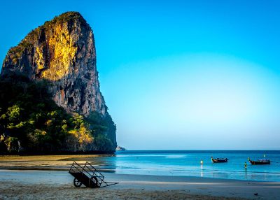 a beach with boats and cart