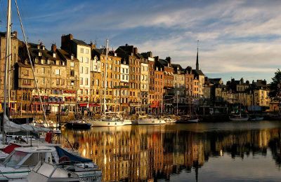 european river city with boats and buildings