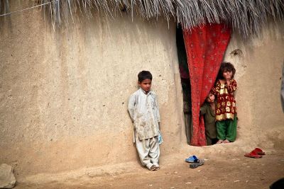 children by adobe wall