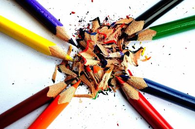 eight colored pencils with shavings