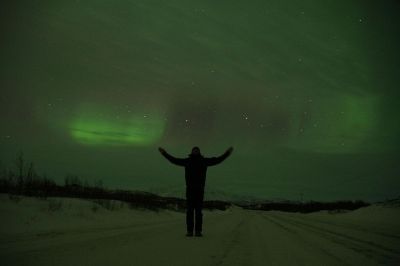 man standing at northern lights