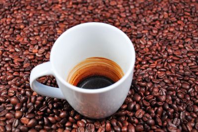 coffee mug sitting on coffee beans