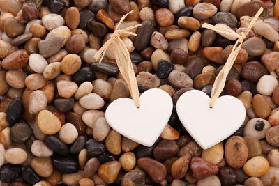 heart tags laying on pebbles