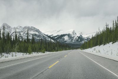 snow capped mountains with highway