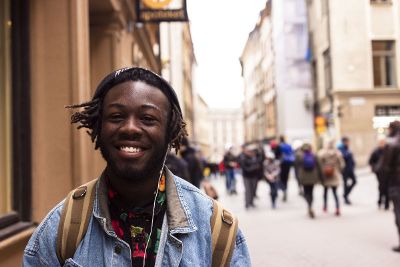 man smiling on city street