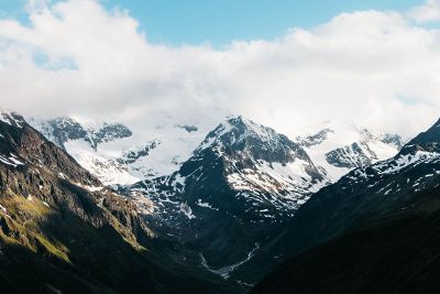 mountains with snow and cloudy sky