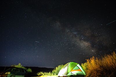 camping under the night sky