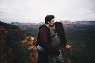 man kissing girl on head