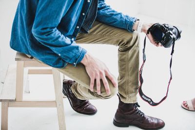 photographer with hand on knee