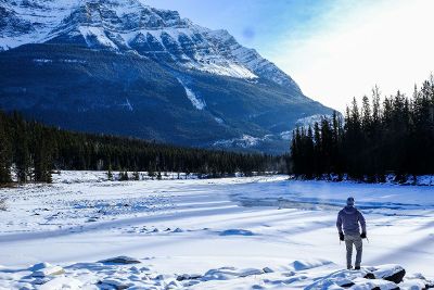 man viewing snowy mountain landscape