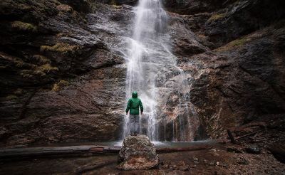 man under waterfalls