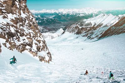 snowboarders going down a mountain