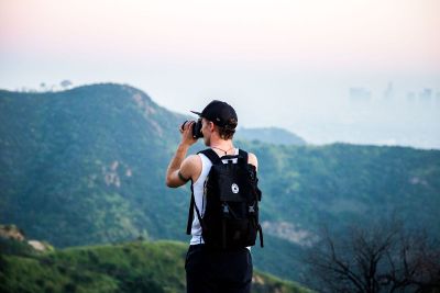 person taking photo of mountains