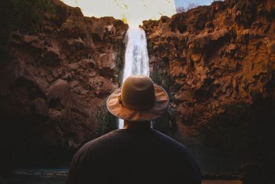 man looking at waterfall