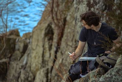 man drawing on cliff