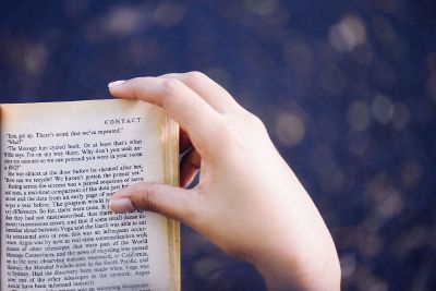 hand holding corner of book