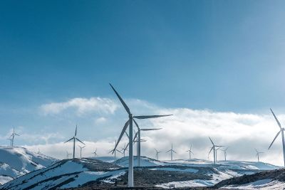 wind farm on snowy hills