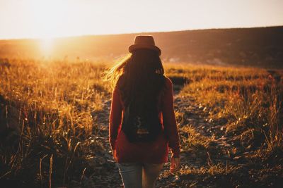 woman walking through field
