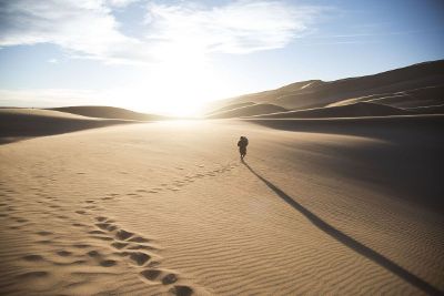 man walking in the desert