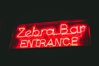 zebra bar neon entrance sign