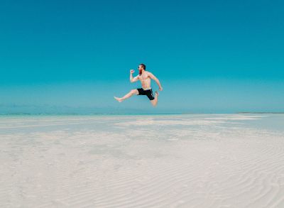 man jumping on beach