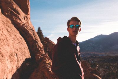 young man standing on mountainside