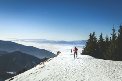 hiker in the snow on a mountain road