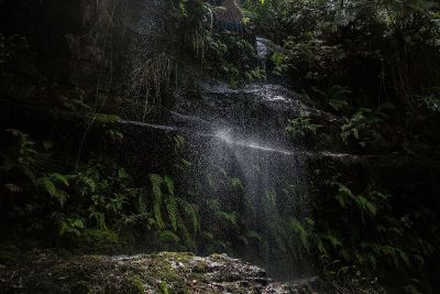 water falling down rock wall